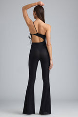 Amara-Petite Metallic Ruched Cut-Out Flared Jumpsuit in Black